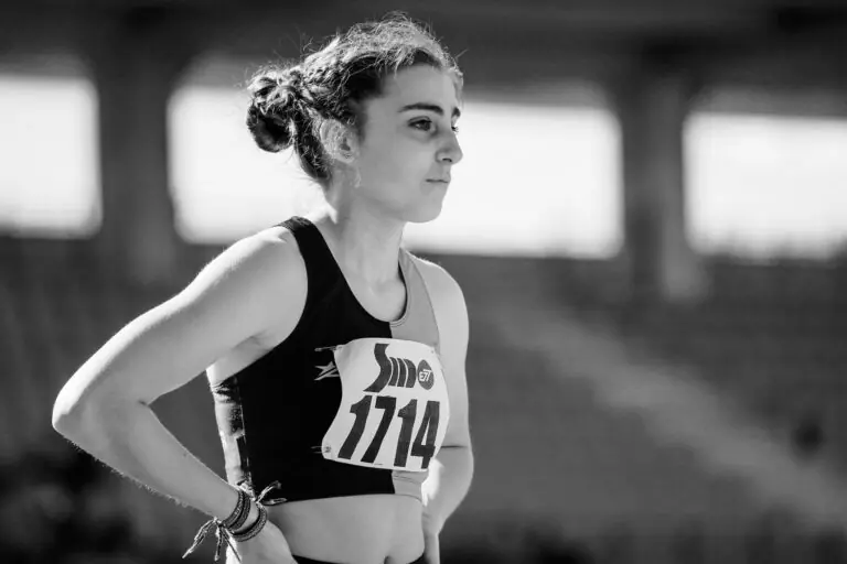 Female athlete on the track after working with a sports dietitian to improve performance